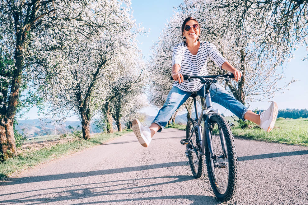 Woman biking outside - 5 Easy Ways to Spring Clean Your Health