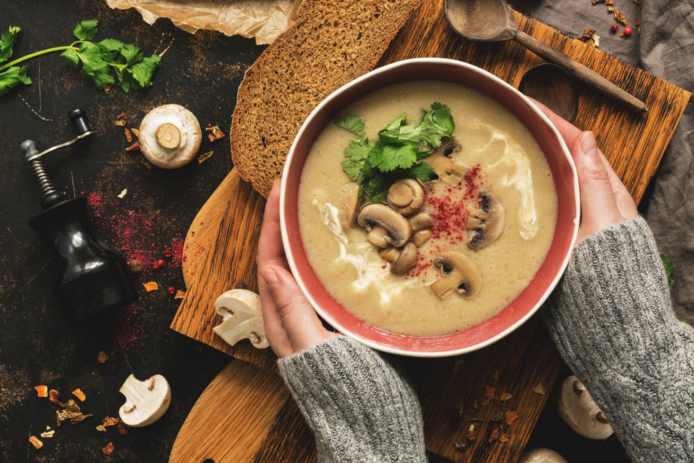 Woman serving Mushrooms soup