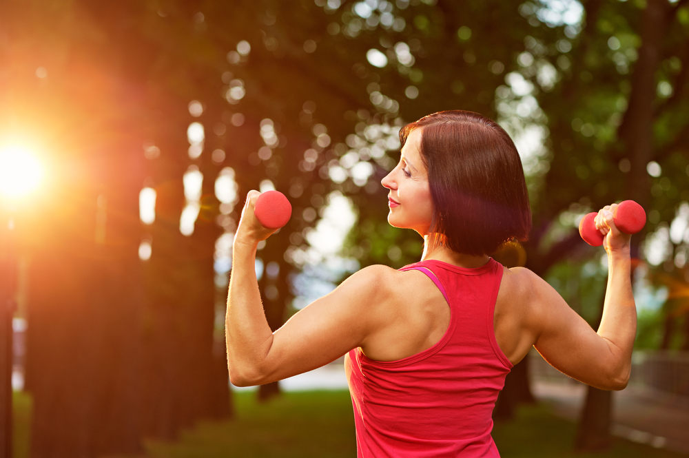 woman working out with dumbbells