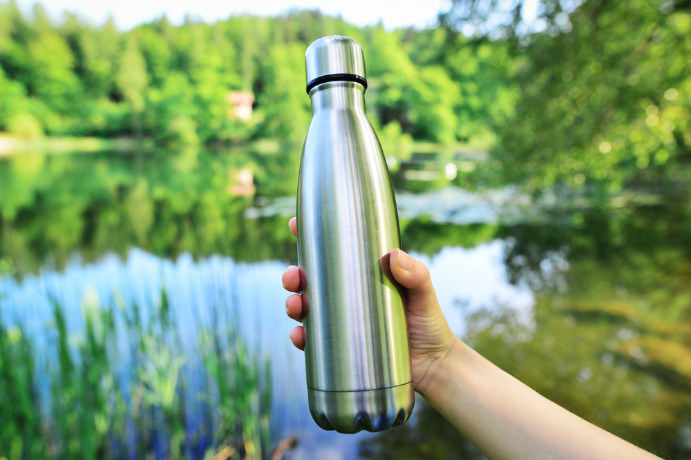 Woman holding stainless steel water bottle